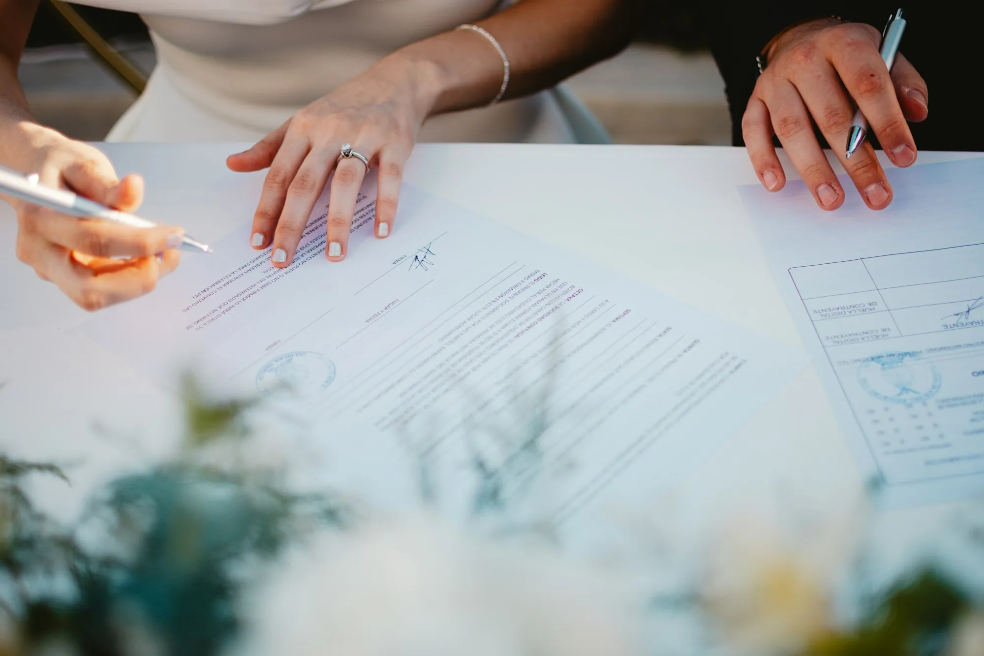 Deux personnes signent un contrat sur une table
